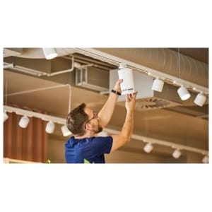 Installazione di diffusori wireless SpotTune su binario luce a soffitto in un locale